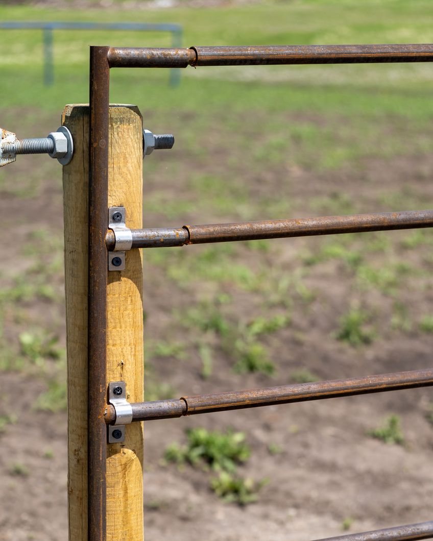 End panel connector capping a Ranchcore panel run, mounted to a wooden post