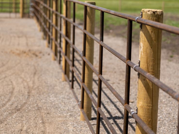 Looking down a Ranchcore panel fence line along a gravel path